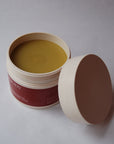 An open jar of Golden Body Butter, the best handcrafted body butter for sensitive skin.