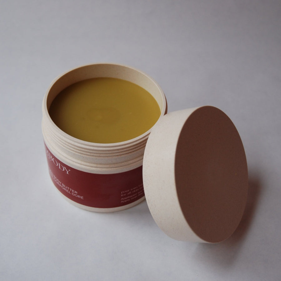 An open jar of Golden Body Butter, the best handcrafted body butter for sensitive skin. 