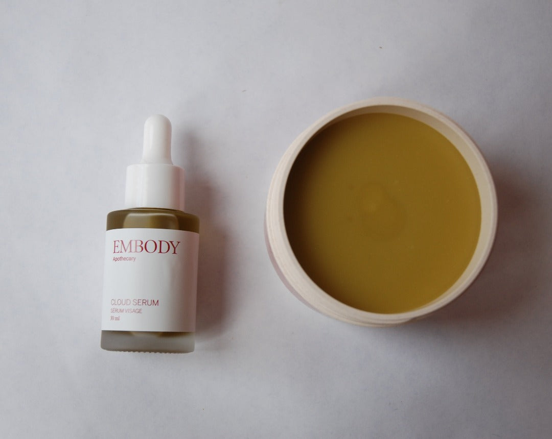 The Cloud Serum and an open jar of Golden Body Butter sit side-by-side. Both products have the same golden colour and are incredibly at soothing sensitive skin, eczema, rosacea, and dermatitis.