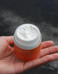 The 100g jar of Sun Kissed Zinc Oxide cream sits in the palm of an open hand.