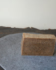 The organic Coffee Scrub soap bar sits on display.