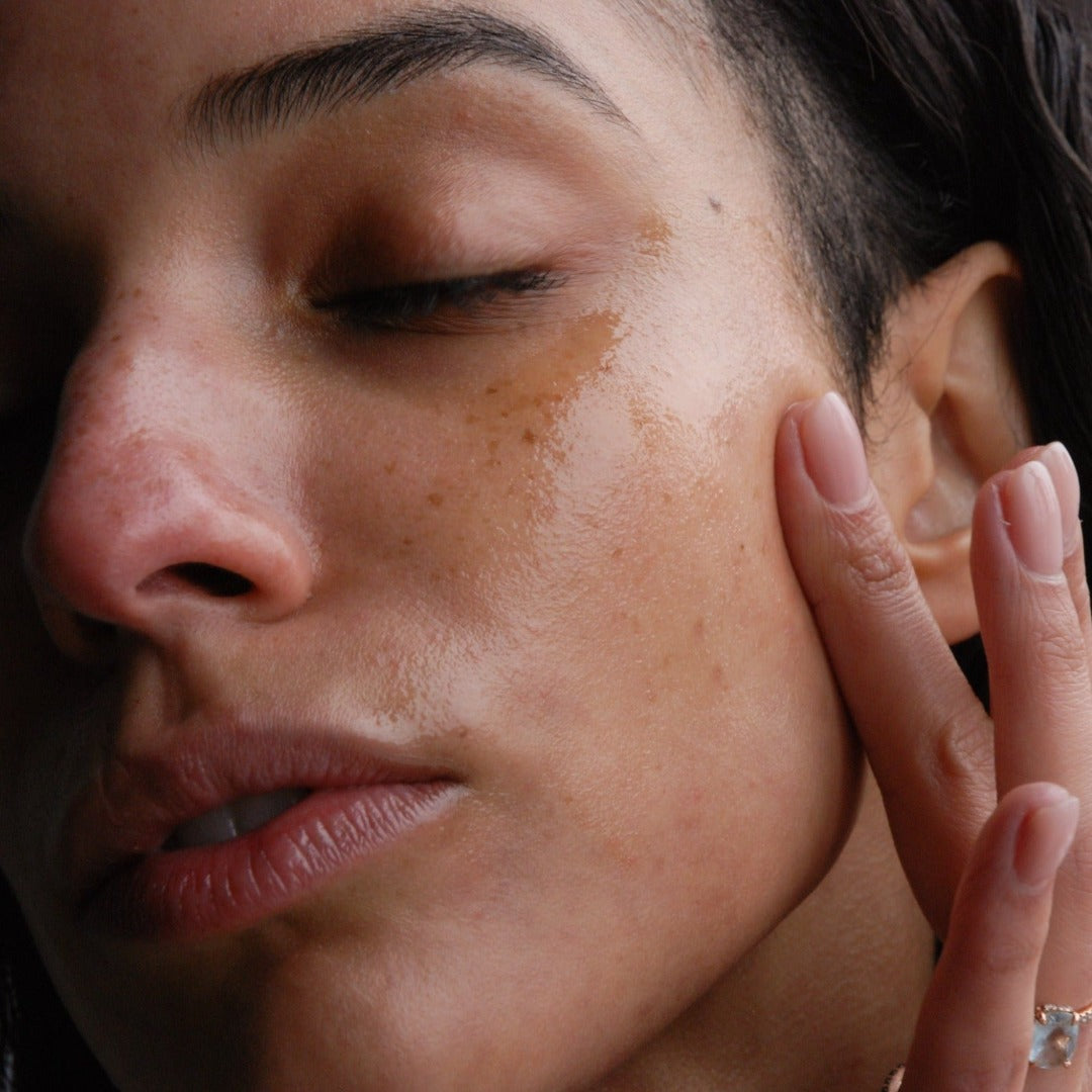 Woman gently applying the Cloud Facial Serum onto her sensitive skin.